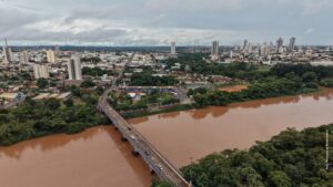Vista aérea de uma cidade com vias, edifícios e áreas verdes, representando o planejamento orientado pelo Plano Diretor.